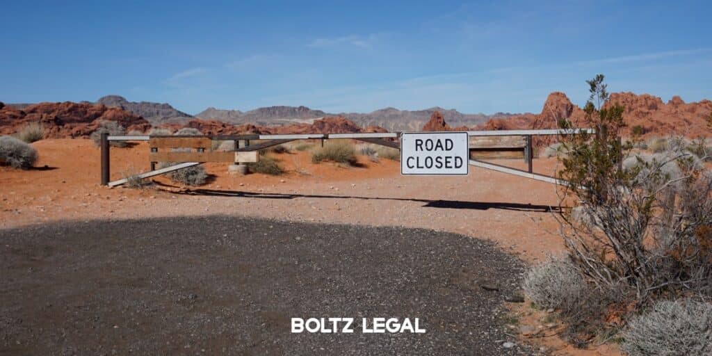 Sovereign Immunity legal graphic showing a closed roadway and barrier, representing limits on government liability under Florida law.